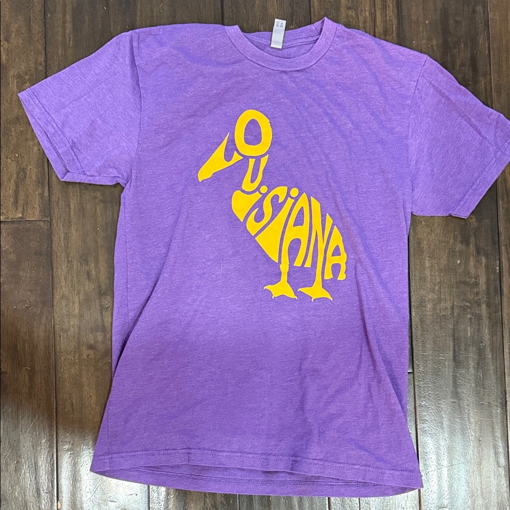 Next Level Apparel Purple Tee with Yellow Pelican Louisiana Graphic